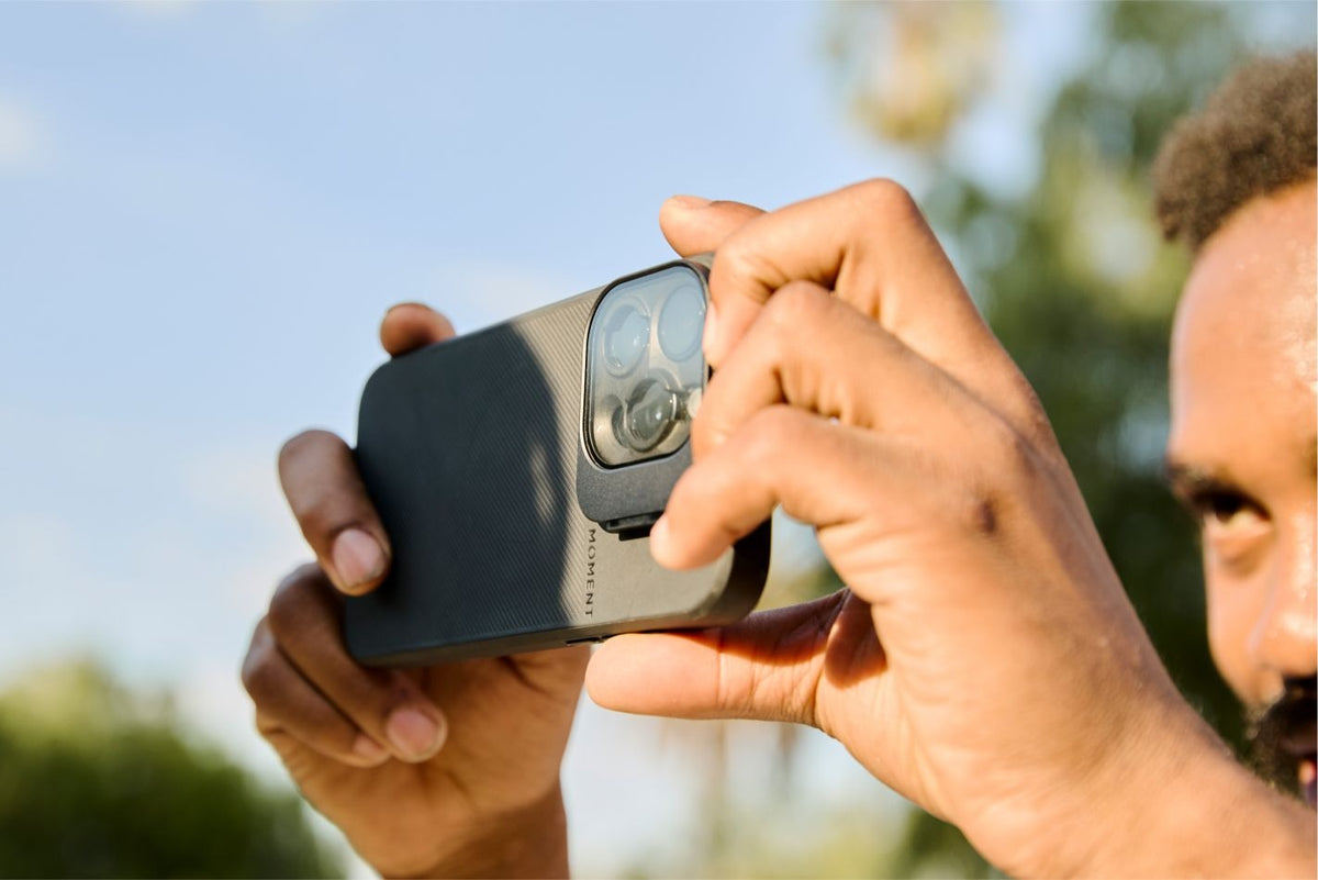 Man holding iPhone with QuickLock filter.