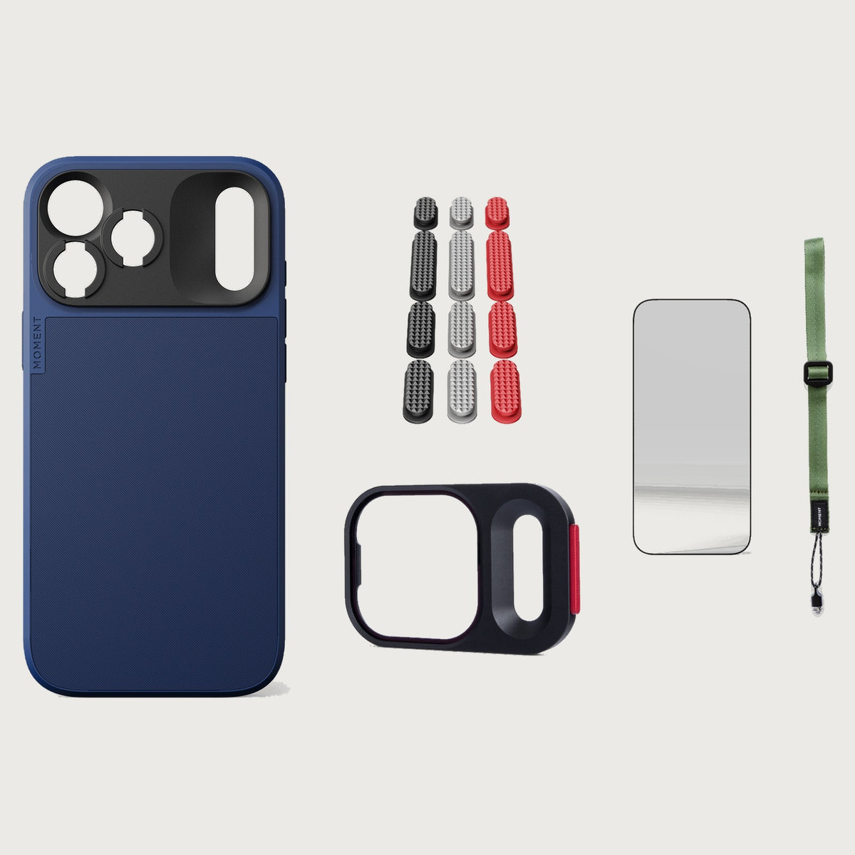 iphone-18-pro-max-case-essentials — Indigo case, Metal Grip Pack (Black/Silver/Red), Olive wrist strap (AR glass + CineClear UV; no drop-in / no cleaning kit)