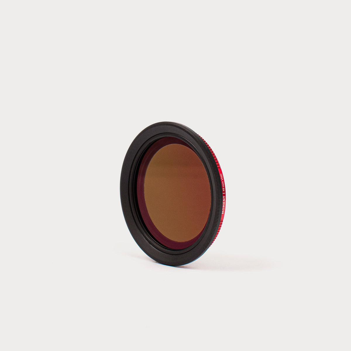 a close up of a red filter on a white surface .