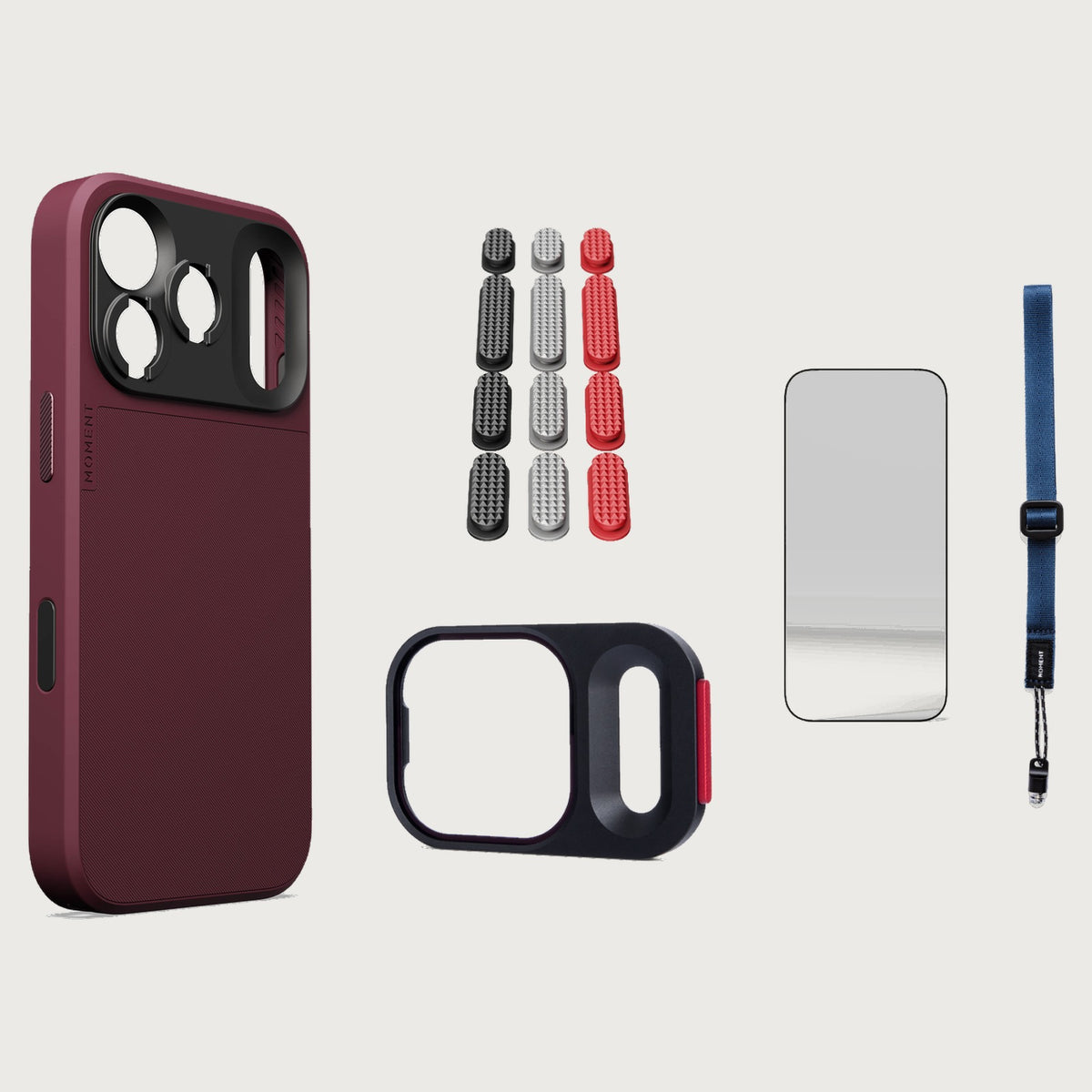 iphone-18-pro-case-essentials — Burgundy case, Metal Grip Pack (Black/Silver/Red), Indigo wrist strap (AR glass + CineClear UV; no drop-in / no cleaning kit)